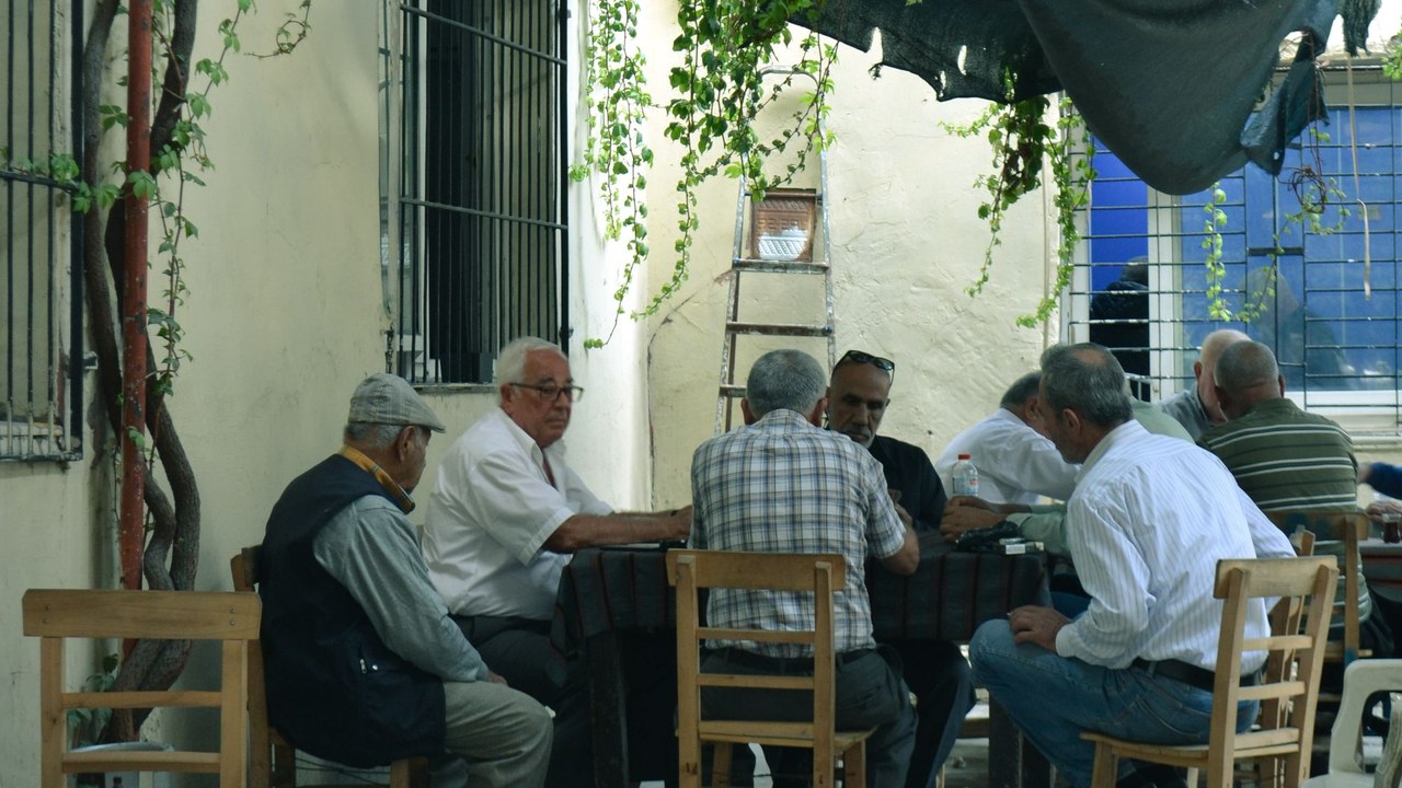 A group of older men sitting around a table together